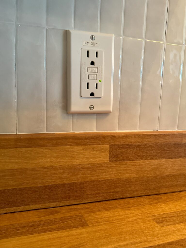 Faux butcher block countertops added with faux rectangle tile backsplash.